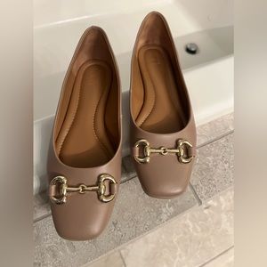 Tan business casual flats with metal hardware decal